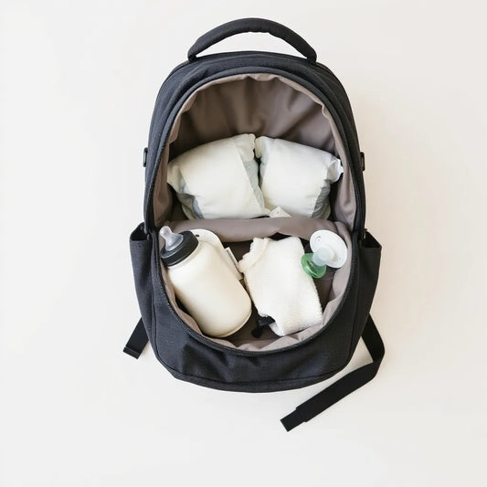 Diaper bag backpack open with organized baby essentials ready for outings
