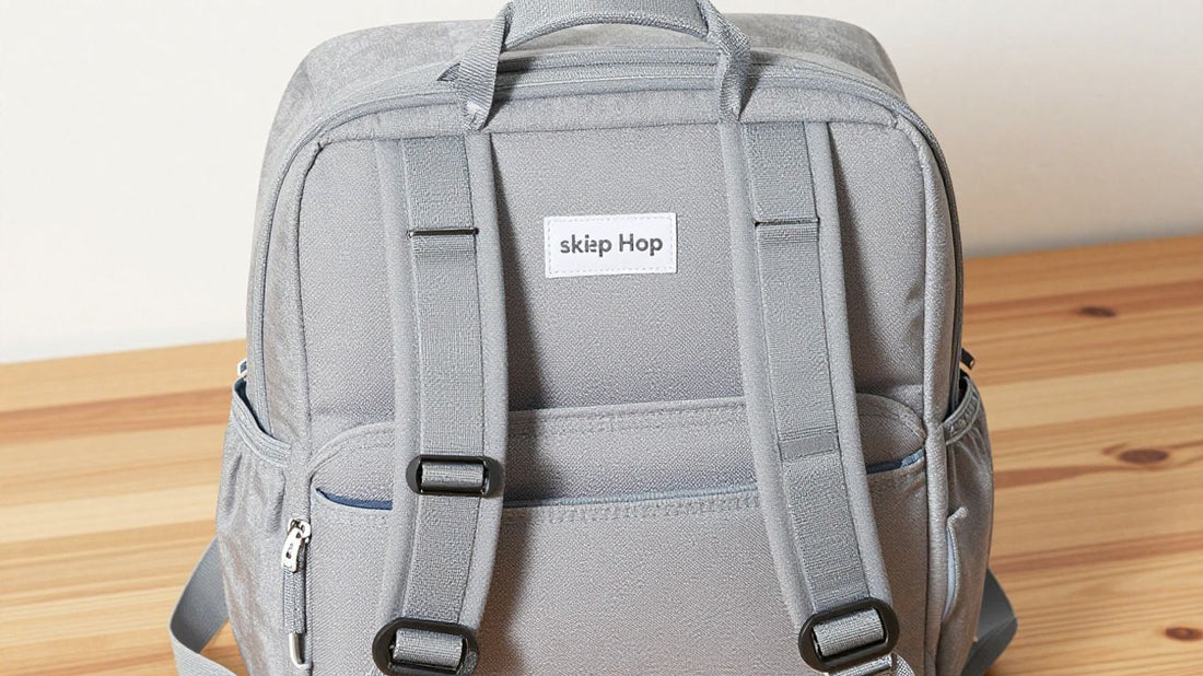 Skip Hop Forma Diaper Backpack on a wooden surface.
